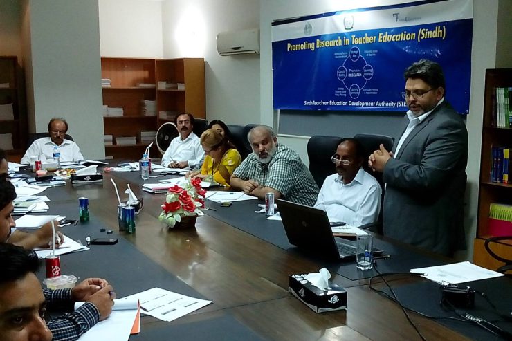 A consultation session beneath a banner reading Promoting Research in Teacher Education (Sindh), carrying the Government of Sindh crest and the FAME logo.